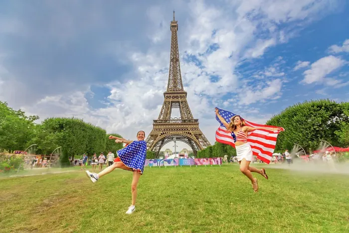 Framed Print : Patriotic American Woman jumping and cheering for Team USA and the Paris 2024 Olympics in front of the Eiffel Tower beach volleyball stadium, Paris, France, Europe Framed Print : Patriotic American Woman jumping and cheering for Team USA and the Paris 2024 Olympics in front of the Eiffel Tower beach volleyball stadium, Paris, France, Europe
