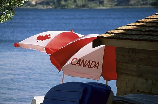 Patriotic umbrellas on the shore of Okanagan Lake, Sun-Oka Beach Provincial Park