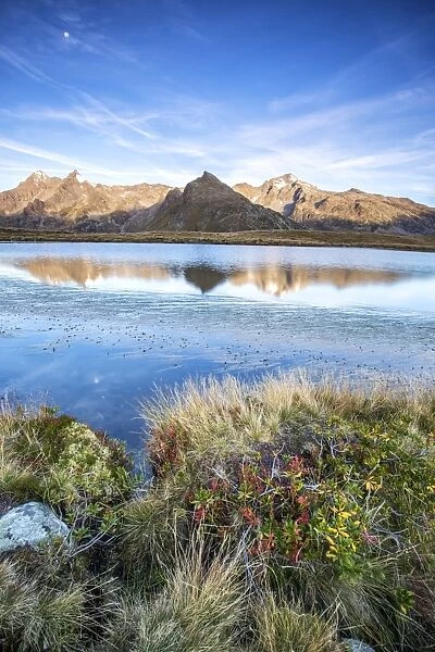 Peak Tambo and Peak Piani are reflected in Lake Andossi at sunrise, Spluga Valley