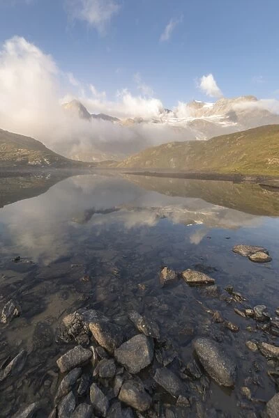 Peaks of mountain range reflected in alpine lake, Bernina Pass, Poschiavo Valley