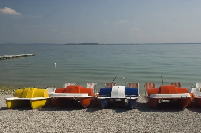 Framed Print : Pedalos on the beach at Monega del Garda