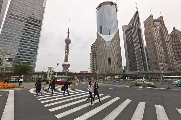 Pedestrian crossing in Pudong, the financial and business centre. Oriental Pearl Tower in centre, Shanghai, China, Asia