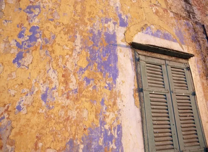 Framed Print : Peeling blue and ochre wall and shutters Framed Print : Peeling blue and ochre wall and shutters
