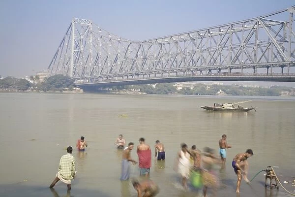 People bathing in Hooghly River, Ghat near Hooghly bridge, Kolkata (Calcutta)