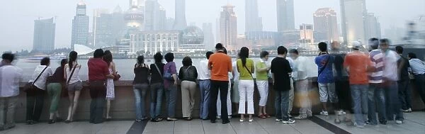 People on the Bund looking over to the Oriental Pearl Tower and the Pudong District