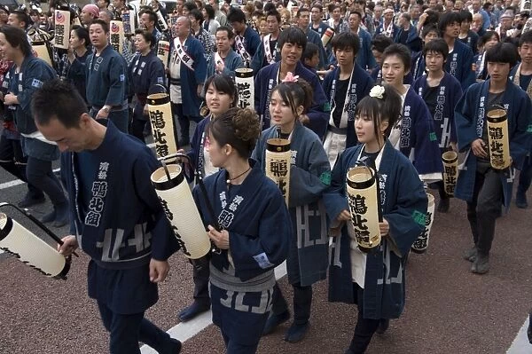 People carrying lanterns during the Gotenyatai Hikimawashi Festival in Hamamatsu
