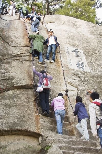 People climbing the steep steps on Hua Shan, a granite peaked mountain