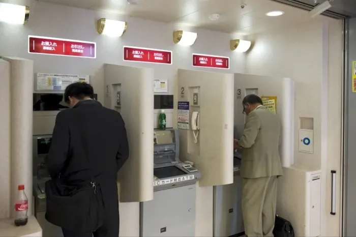 Framed Print : People doing after-hours banking at bank teller machines in Japan, Asia Framed Print : People doing after-hours banking at bank teller machines in Japan, Asia