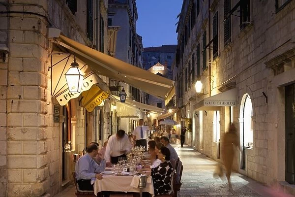 People eating at outdoor restaurant at dusk in the old town, Dubrovnik, Croatia, Europe