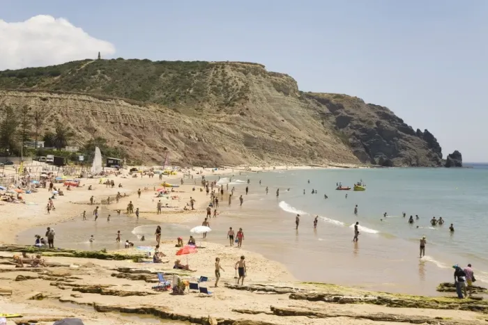 Framed Print : People enjoy sunshine and golden sand at the Praia da Luz beach in Lagos Framed Print : People enjoy sunshine and golden sand at the Praia da Luz beach in Lagos