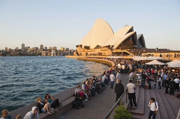 People enjoying the evening in Sydney, drinking at the Opera Bar in front of Sydney Opera House, UNESCO World Heritage Site, Sydney, New South Wales, Australia, Pacific