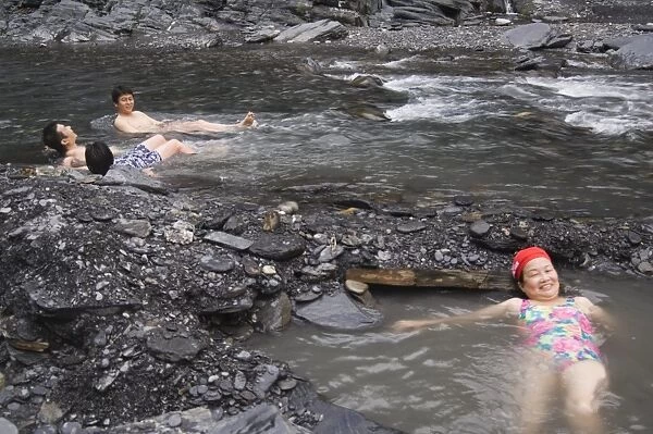 People enjoying natural hot river water of Tona hotspring bath resort