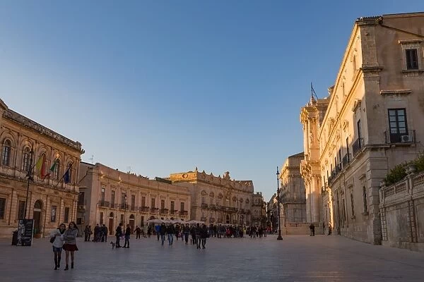 People enjoying passeggiata in Piazza Duomo on the tiny island of Ortygia, UNESCO