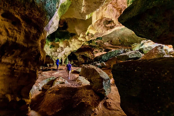 People exploring sea caves on North Caicos, Turks and Caicos Islands, Atlantic