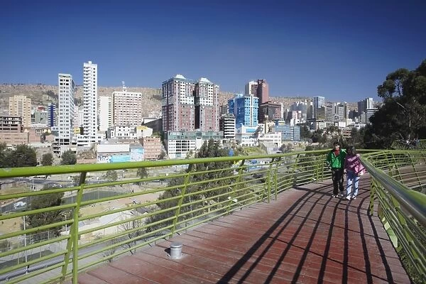 People on footbridge with view of downtown La Paz, Bolivia, South America