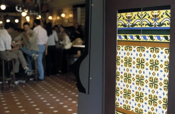Framed Print : People inside a tapas bar and a detail of decorative tiled wall Framed Print : People inside a tapas bar and a detail of decorative tiled wall