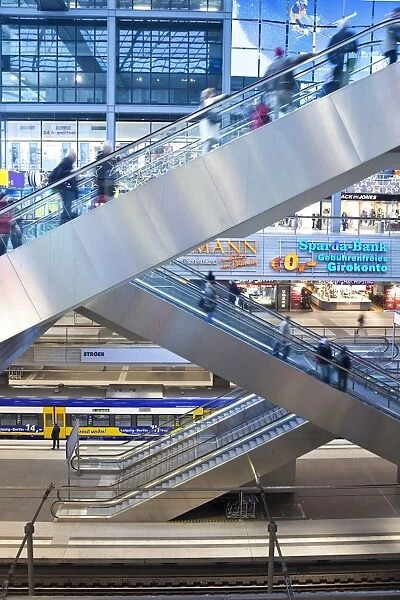 People moving up escalator at new modern main railway station, Berlin, Germany, Europe