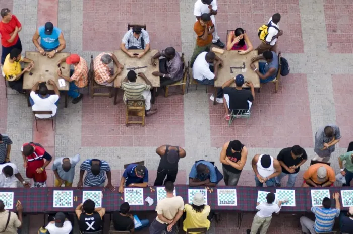Framed Print : People playing chess and dominoes at a school festival in Parque Cespedes Framed Print : People playing chess and dominoes at a school festival in Parque Cespedes