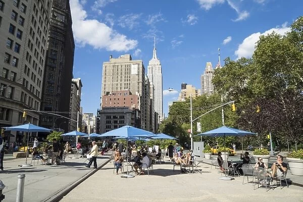 People relaxing in the Flat Iron District, Empire State Building in view, Manhattan, New York City, New York, United States of America, North America