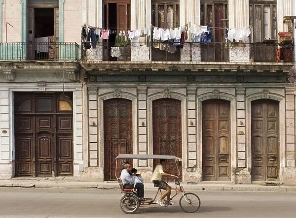 People riding in a rickshaw, central Havana, Cuba, West Indies, Central America