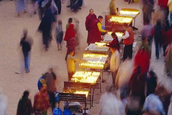 People selling butter candles to believers opposite