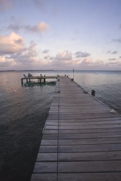Framed Print : People sitting on chair on jetty at sunrise, Tobaco Caye, Belize, Central America Framed Print : People sitting on chair on jetty at sunrise, Tobaco Caye, Belize, Central America