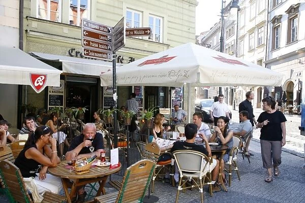 People sitting at an outdoor cafe in Malostranske Namesti Square, Mala Strana