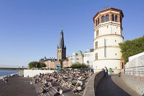 People on stairs by the Rhine, Lambertus Church and Schlossturm tower, Dusseldorf, North Rhine Westphalia, Germany, Europe