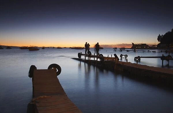 People standing on pier at sunset, Copacabana, Lake Titicaca, Bolivia, South America
