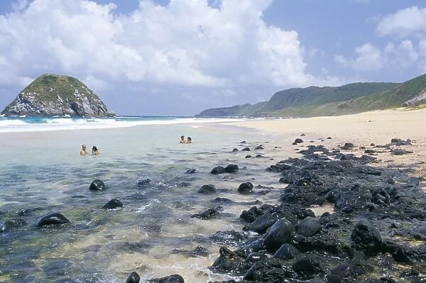 People swimming at Praia do Leao beach, Parque Nacional de Fernando de Norohna
