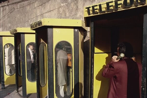 People in telephone kiosks on Galata Bridge