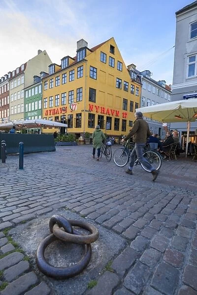 People walk in the pedestrian roads of the entertainment district of Nyhavn, Copenhagen