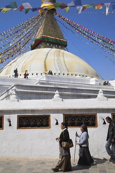 People walking round base of stupa