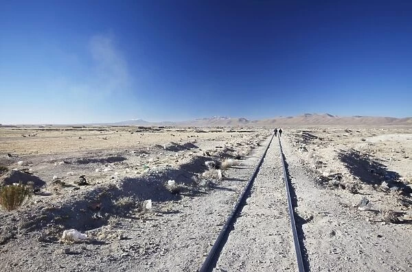 People walking along train tracks, Uyuni, Potosi Department, Bolivia, South America