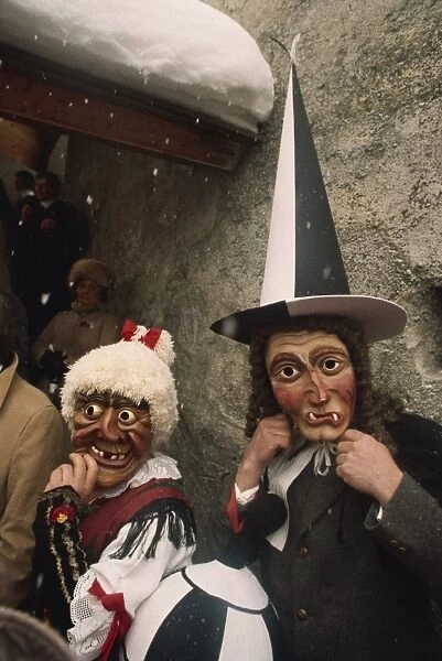 People wearing masks, one with a tall pointed hat, Fasnacht carnival, Imst