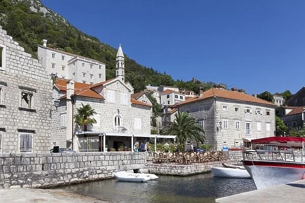 Perast harbour with cafes and boats moored up, Bay of Kotor, UNESCO World Heritage Site, Montenegro, Europe