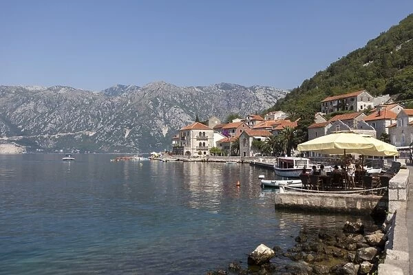 Perast harbour and promenade with tourists and inhabitants eating and drinking, Bay of Kotor, Montenegro, Europe