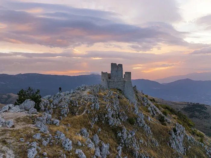 Framed Print : A person admires the Rocca Calascio castle during an autumn sunrise, National Park of Gran Sasso and Monti of Laga, Abruzzo, Italy, Europe Framed Print : A person admires the Rocca Calascio castle during an autumn sunrise, National Park of Gran Sasso and Monti of Laga, Abruzzo, Italy, Europe