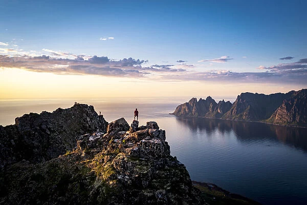 Person contemplating sunset from top of mountains, Senja island, Troms county, Norway