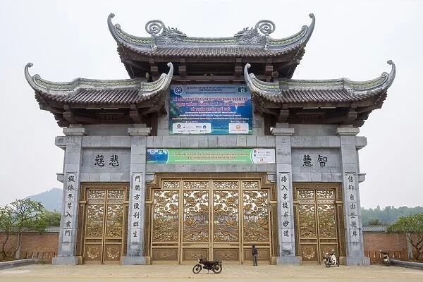 A person looking up at Bai Dinh Temple (Chua Bai Dinh) gate, Gia Vien District, Ninh Binh Province