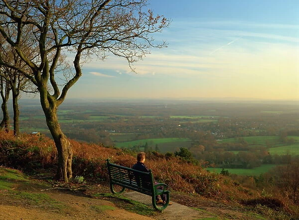 Person looking across the Weald with a view for 25 miles to the South Downs from the Greensand Ridge, Pitch Hill, Ewhurst, Surrey, England, United
