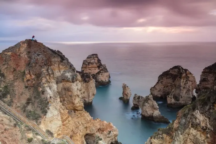Framed Print : Photographer on top of cliffs surrounded by sea under the pink sky at sunrise, Ponta Da Piedade Framed Print : Photographer on top of cliffs surrounded by sea under the pink sky at sunrise, Ponta Da Piedade
