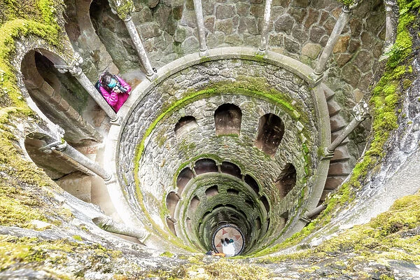 Photographer at the top of the spiral stairs inside the towers of Initiation Well