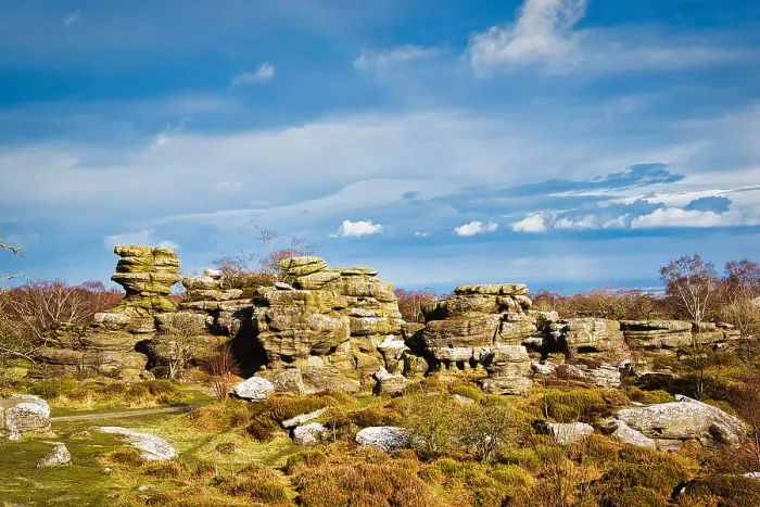 Framed Print : Picturesque rocky landscape with unique rock formations under a blue sky with fluffy clouds at Brimham Rocks, in North Yorkshire Framed Print : Picturesque rocky landscape with unique rock formations under a blue sky with fluffy clouds at Brimham Rocks, in North Yorkshire