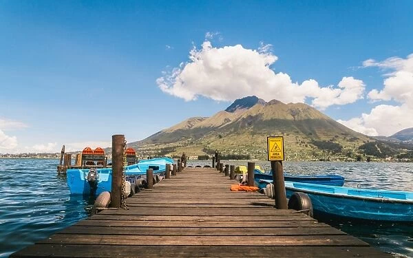 A pier and boat on Lago San Pablo, at the base of Volcan Imbabura, close to the famous