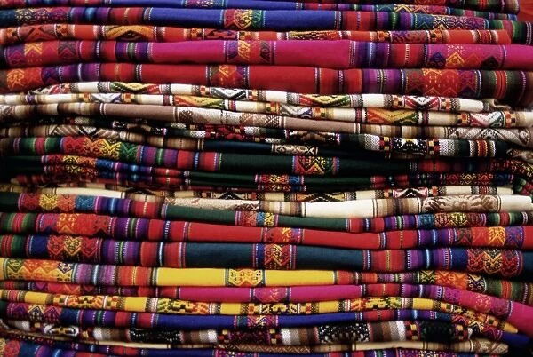 Detail of a pile of colourful ponchos
