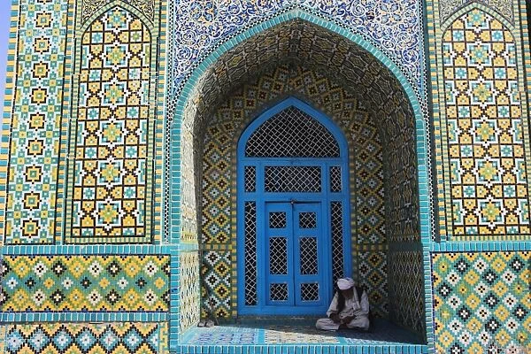 Pilgrim sits in a niche at the Shrine of Hazrat Ali, who was assassinated in 661