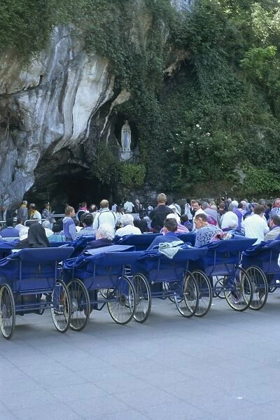 Pilgrims at grotto, Lourdes, Midi Pyrenees, France, Europe