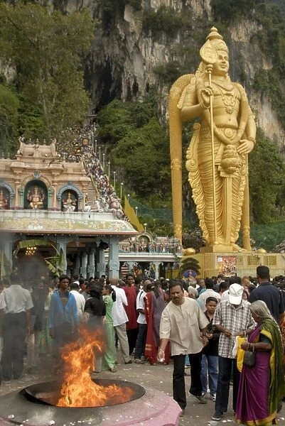 Pilgrims throwing offerings into holy fire during the
