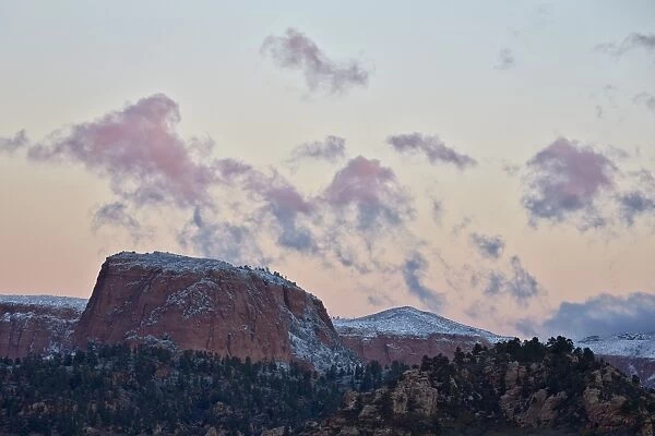 Pink clouds at dawn over sandstone formations covered with a dusting of snow, Zion National Park